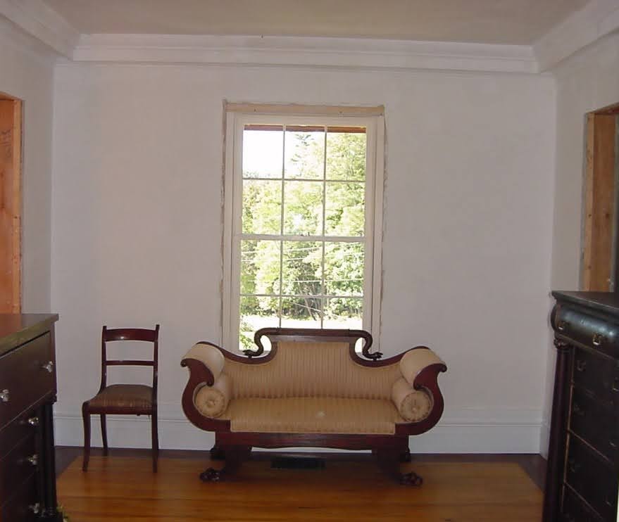 Second-floor hall, Empire sofa beneath hand-made window, dark chests at either side